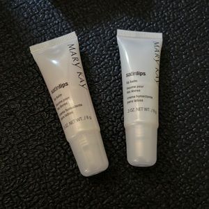 Two Mary Kay lip balms.